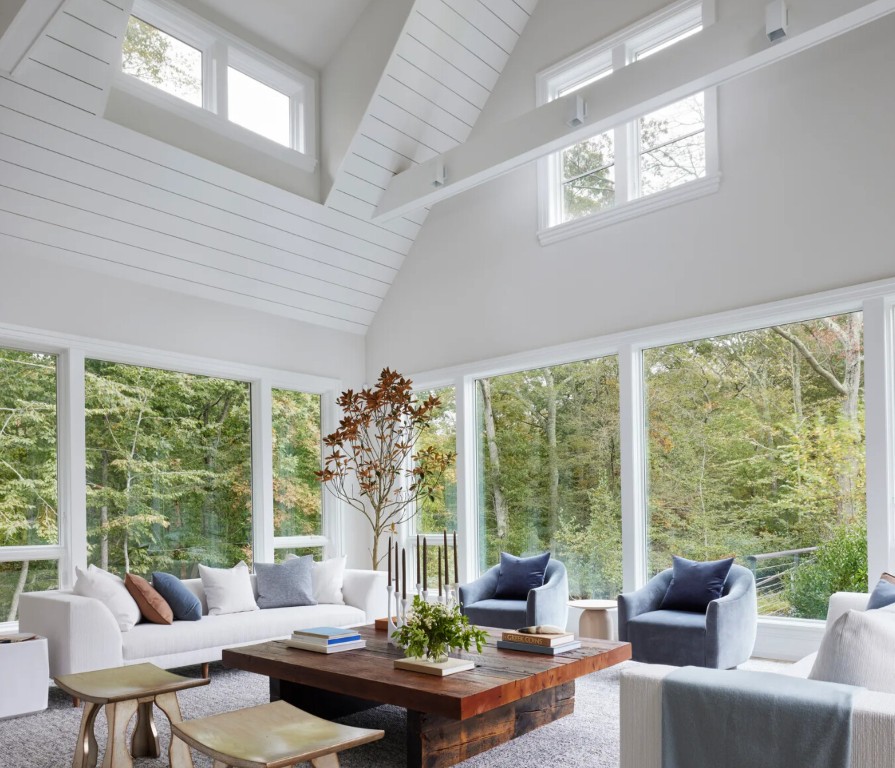 Modern four-season sunroom with high ceilings and abundant natural light